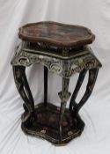 A Chinese black lacquered jardiniere stand, the shaped top above a pierced frieze on six legs and
