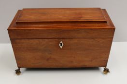 A Victorian rosewood sarcophagus tea caddy, the rectangular shaped boxwood strung top enclosing a