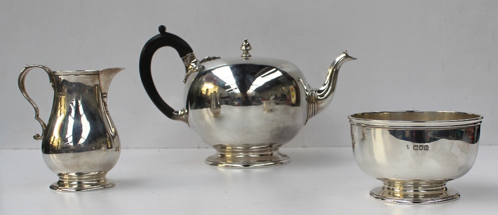 A George V silver three piece tea set, London, 1915, CS Harris & Sons Ltd, also engraved to the base