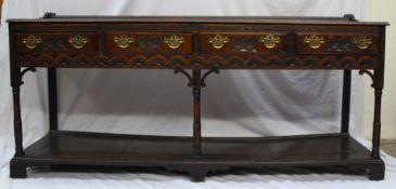 An 18th century oak South Wales dresser base, the rectangular planked top above four drawers and