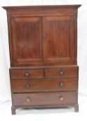 An 18th century oak linen press, the moulded cornice above a pair of panelled cupboard doors