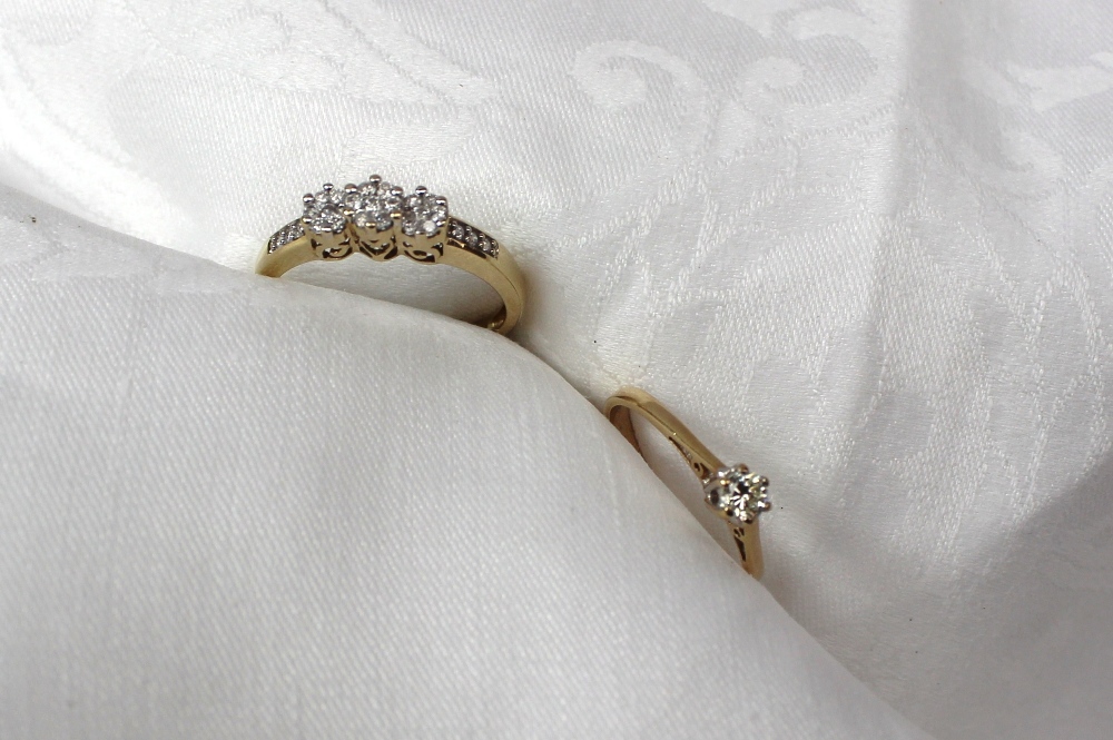 A diamond cluster ring to a white metal setting and shank together with a solitaire diamond ring,
