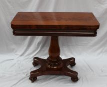 A Victorian mahogany card table, the hinged rectangular top with rounded corners enclosing a baize