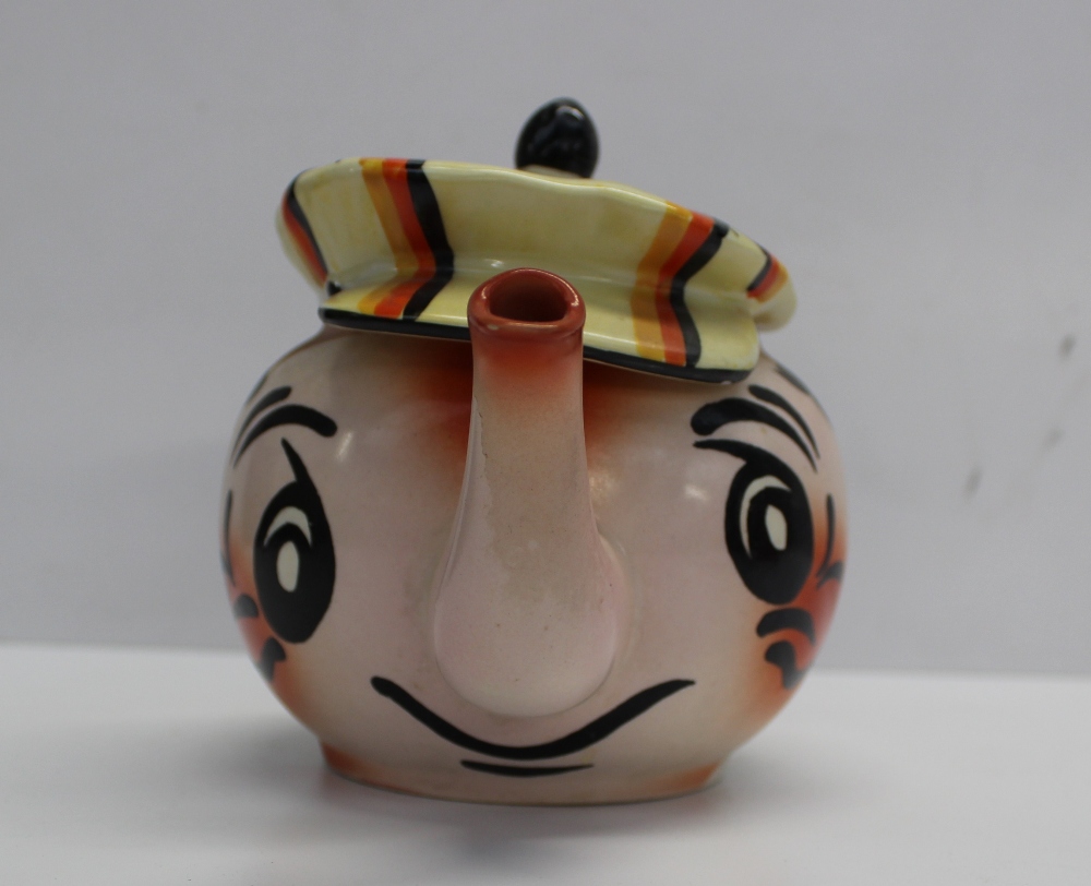 A Wade novelty hand painted teapot in the form of a man wearing a flat cap, gilt mark