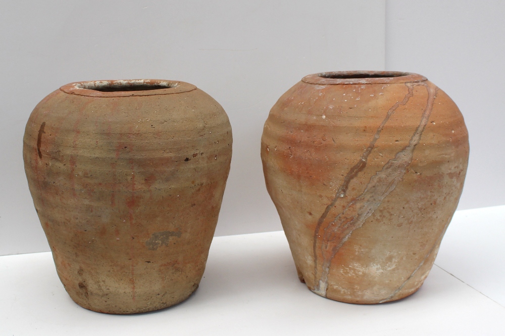 A pair of Chinese Redware terracotta storage pots, possibly 2,500 BC in date, typed note attached