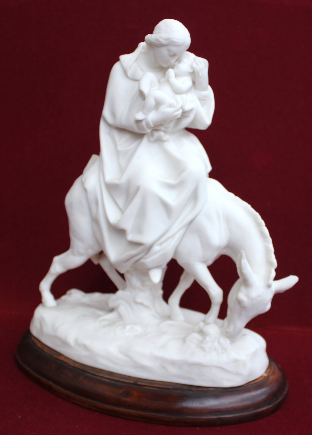 A Minton Parian figure group: "The Flight Into Egypt" modelled as The Virgin cradling Jesus, astride