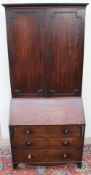 A George III mahogany bureau bookcase, the moulded cornice above a pair of panelled doors