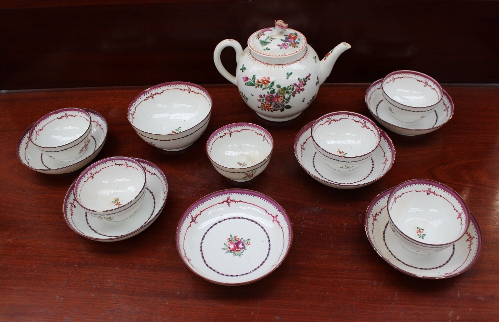 An 18th century porcelain teapot of globular form with polychrome decoration of flowers and