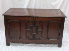 An 18th century oak coffer, the rectangular planked moulded top above a three panelled front on