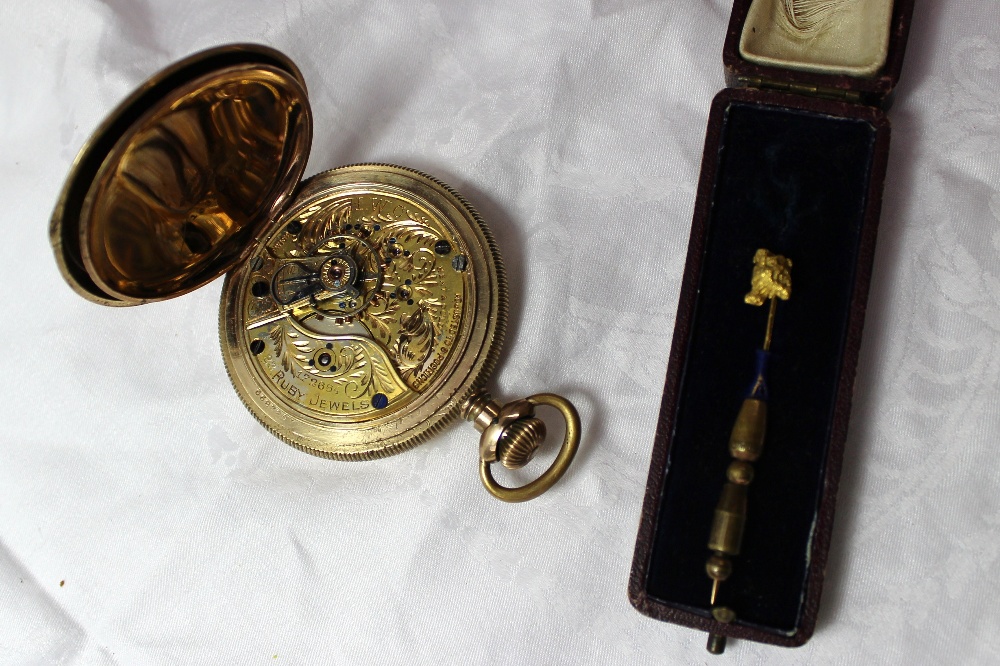 A yellow metal nugget stick pin together with a yellow metal hunter pocket watch, the dial with