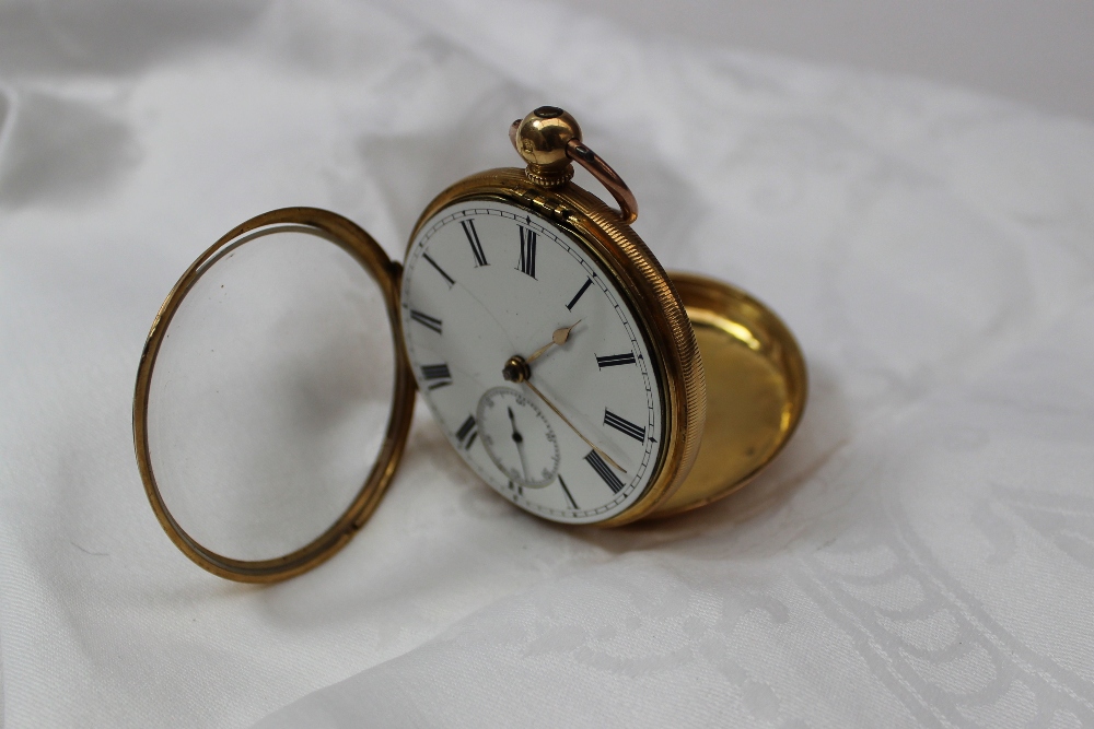 An 18ct yellow gold key wound open faced pocket watch the enamel dial with Roman numerals and a