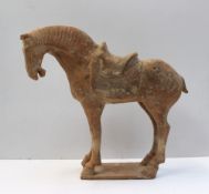 A Chinese red terracotta model of a horse with an open mouth & detailed mane, possibly Tang Dynasty,