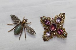 A yellow and white metal brooch in the form of a fly set with diamond wings, ruby eyes, tigers eye
