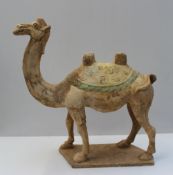 A Chinese earthenware model of a camel, some original pigment remaining, possibly Tang Dynasty, 45