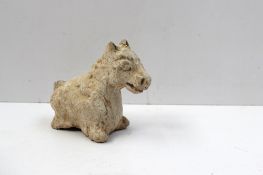 A Chinese terracotta figurine of a stylised zodiac horse, white pigment remaining, possibly Yuan