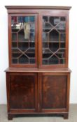 A Victorian mahogany bookcase, the moulded cornice above astragal glazed doors, the base with a pair