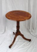 A Victorian mahogany tripod table, the circular top on a reeded column and three splayed legs, 63 cm