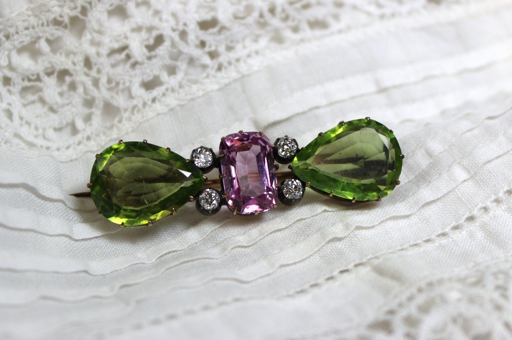 An amethyst, peridot and diamond bar brooch in the suffragette colours, the central rectangular