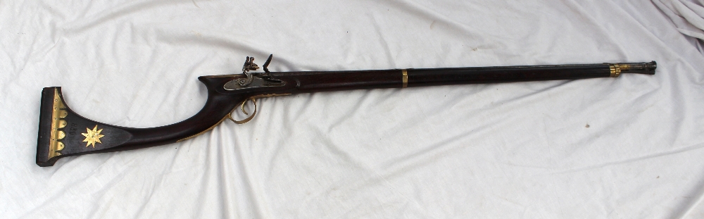 An Afghan flintlock rifle, with an 88 cm barrel, the stick with brass decoration