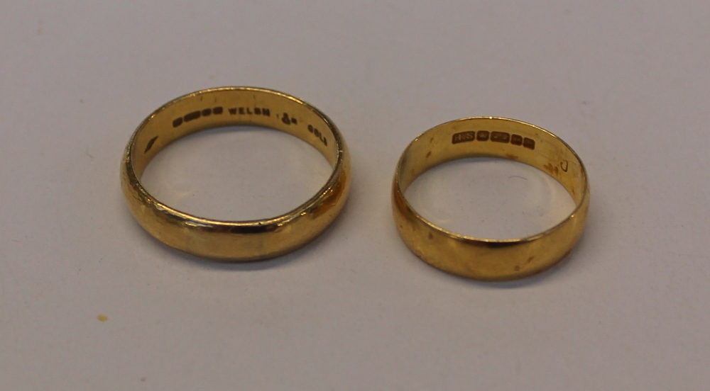 A 22ct yellow gold wedding band marked Welsh gold together with another 22ct yellow gold wedding