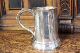 A George II silver tankard, of tapering cylindrical form with a scrolling handle and heart shaped