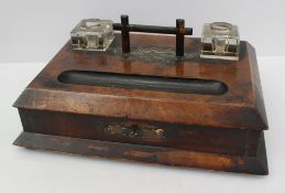 A walnut desk standish, with a pair of square class ink wells, with a base drawer containing in