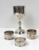 A Victorian silver chalice, embossed with swags of flowers, the knopped stem on a spreading foot,
