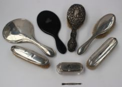 A George V silver backed clothes brush, Birmingham, 1918, together with other silver backed brushes,