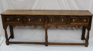 A 17th century style oak dresser base, the rectangular top above four drawers on turned baluster