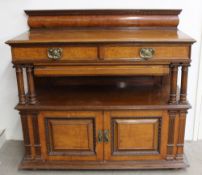 An Edwardian oak buffet, the raised bowed top above a moulded rectangular top with two short drawers