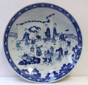 A large Chinese porcelain dish, decorated to the centre with children at play, 36.5cm diameter,
