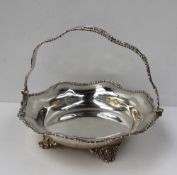 A George V silver swing handled cake basket, of shaped circular form, the edge decorated with