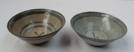 A pair of Chinese porcelain bowls, with line decoration, possibly from the Sung Dynasty, 14 cm diam
