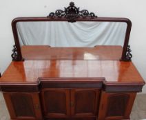 A Victorian mahogany mirrorback sideboard, with a scrolling leaf cresting above a rectangular