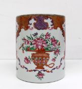 An 18th century Chinese famille rose cylindrical tankard decorated with a central vase of flowers