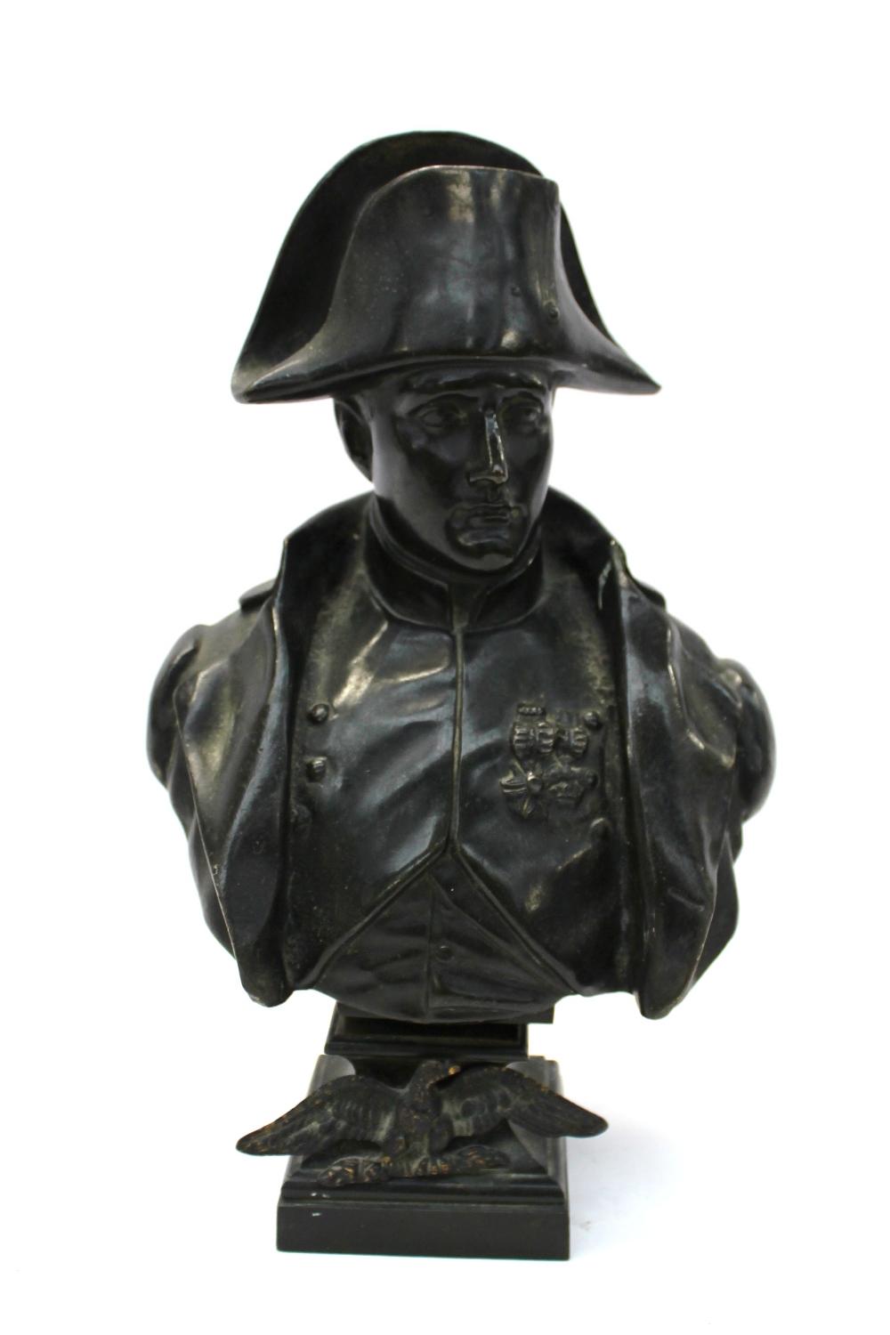A bronze bust of Napoleon wearing a hat and jacket, with medals on his chest, the base mounted