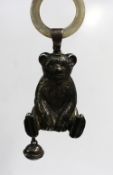 A George V silver babies rattle in the form of a teddy bear with one bell and a mother of pearl