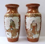 A pair of Japanese kutani vases decorated with Geisha and birds to a red and gold ground, signed