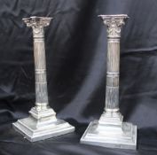 A pair of late Victorian silver candlesticks, the removable beaded sconce above a swag decorated