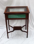 A modern mahogany bijouterie table, the rectangular top with a beveled glass top and glazed sides on