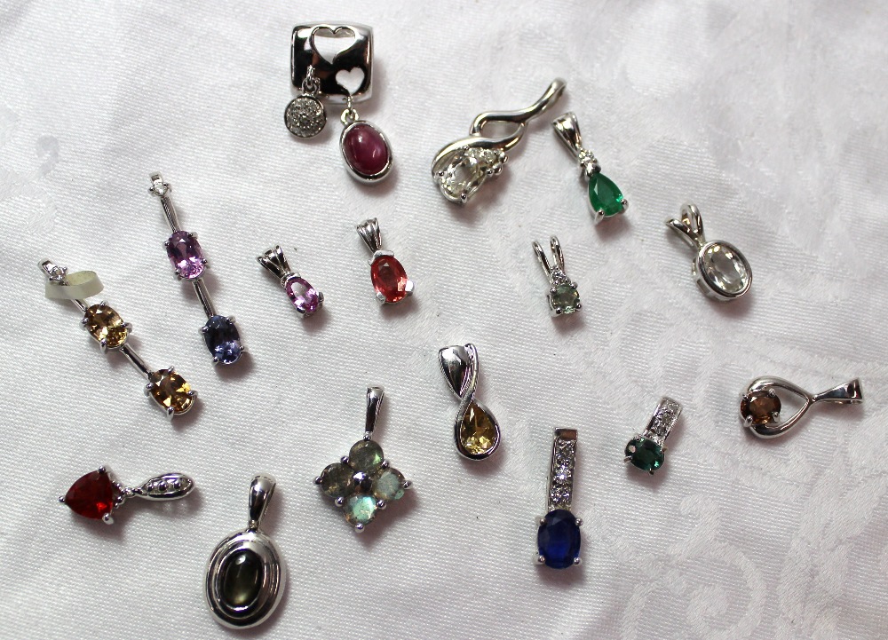 A collection of 9ct white gold and white metal semi precious gem set pendants