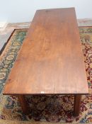 A late 19th early 20th century pine refectory table, with a rectangular top on four square chamfered