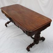 A Victorian mahogany centre table, the rectangular top above a carved shaped frieze on leaf carved