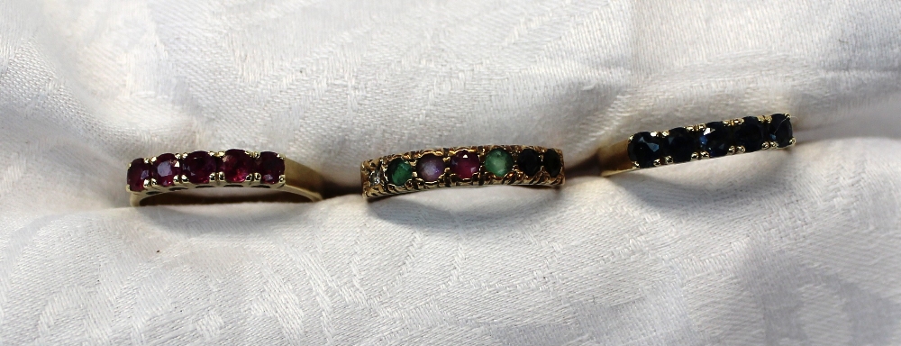 A 9ct yellow gold line ring set with ruby, sapphires, emeralds and a diamond together with a ruby