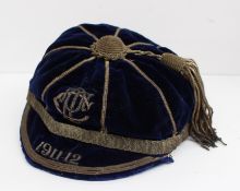 A blue velvet sporting cap with metal thread, initialled and dated 1911-12