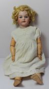 A Simon & Halbig 1249 bisque head doll, with closing blue eyes, open mouth, teeth and pierced ears