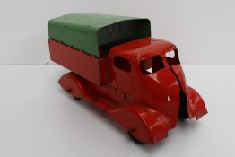 A Lions Bros covered lorry, in orangey red with removable Green tinplate back, lacking front
