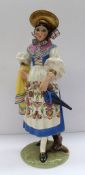A Lenci pottery figure of lady holding an umbrella with a yellow shawl over her arm, her dress