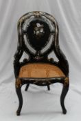 A Victorian papier mache spoon back chair inlaid with mother of pearl, painted with flowers and