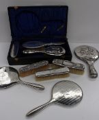 A George V silver backed part dressing table set, Birmingham, 1919, comprising a hand mirror, hair